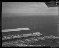 Aerial view of San Pedro harbor with ships from the Navy's Pacific Fleet in the background