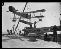 Sailors mount seaplane onto catapult during training exercise aboard the USS West Virginia, 1924-1939