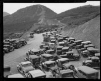 Cars on the road through Griffith Park with laborers in the background widening the road, Los Angeles 1933