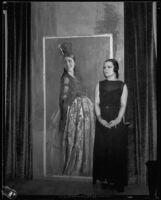 Artist Maroussia Valero standing next to her painting of a spanish woman, circa 1932