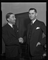 Municipal Court Judge Arthur Crum shakes hands with writer H. H. van Loan, Los Angeles, 1935