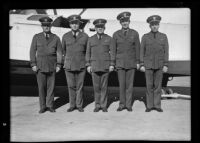 Commander Knefler Mcginnis with 4 other officers the VP-10 Squadron, stand beside a Navy seaplane, San Francisco, 1933