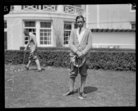 Golfer James C. Ward posing with a putter, 1921-1929