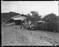 Man with a shovel digging his car out after a catastrophic mudslide, La Crescenta-Montrose, 1934