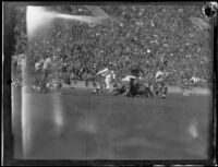 Stanford Cardinal attempts a tackle on the USC ball-carrier during a football game, Los Angeles, 1925