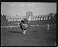 Notre Dame shamrock stands on the Coliseum's field during the USC and Notre Dame game, Los Angeles, 1928