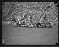 USC's Orv Mohler stumbles as he carries the football through Utah's defense, Los Angeles, 1932