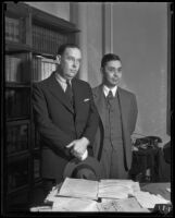 Clarence M. Fuller and Clifford Thoms stand in an office, Los Angeles, about 1934