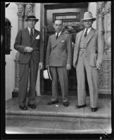 District Attorney Buron Fitts, Ernest E. Noon and Beverly Hills Chief of Police Blair pose on the front steps of the Gettle residence, Beverly Hills, 1934