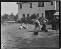 Gettle children posing for photographers on the lawn of their home, Beverly Hills, 1934
