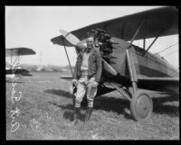 Art Goebel standing in front of his monoplane, probably at Mines Field, Los Angeles, 1928
