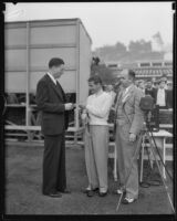 Unidentified golfer accepts a paper at the Pasadena Open, between 1929-1938