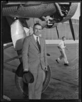Governor of Nevada, Morley Griswold poses next to airplane, 1934-1935