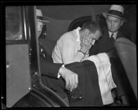 Assailant William Hardy handcuffed in a car with detectives, Los Angeles, 1935