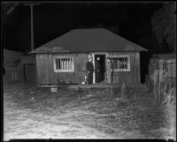 Detectives entering the bungalow of John H. and Rose Marie Happel, Los Angeles, 1934