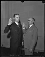 Judge Clarence L. Kincaid being sworn in by an unidentified man, Los Angeles, 1931-1939