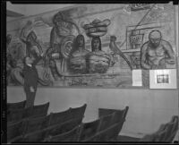 At a mural exhibition at the Los Angeles Central Library, artist Leo Katz points to an area of a cartoon drawing for the Frank Wiggins Trade School mural, Los Angeles, 1934