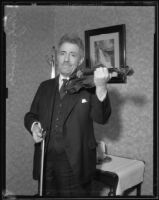 Fritz Kreisler holding his violin, Los Angeles, circa 1930-1939