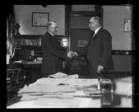 Judge J. W. Summerfield shakes hands with Judge J. B. Landis, [between 1920 and 1927]