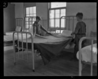 Two boys making a bed at the Lark Ellen Home for Boys, Sawtelle (Los Angeles), 1924