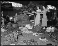 Dorothy Marshall and Manette Green at the LA County Fair with a replica of the first wine press in Escondido Valley, Pomona, 1934