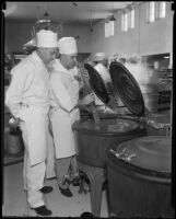 Cooks in the Los Angeles County General Hospital kitchen stir a vat of liquid, Los Angeles, 1934