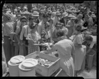 Crowds of people attending the Sheriff's Relief Association barbecue line up to receive food, Los Angeles, 1934
