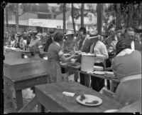 People attending the Sheriff's Relief Association barbecue line up to receive food, Los Angeles, 1934