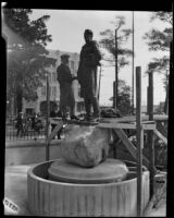 Sculptor Henry Lion competing the installation of his statue of Felipe de Neve in La Plaza Park, Los Angeles, 1932
