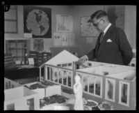 Dr. Lokrantz and a miniature model of a children's medical center, Los Angeles, 1927