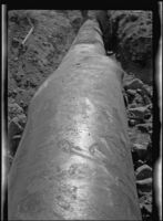 Close-up view of a damaged Los Angeles Aqueduct feeder pipe, Inyo County vicinity, [about 1927]