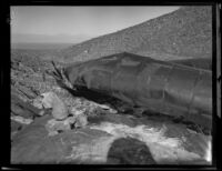 Close-up view of a large section of dynamited pipe along the Los Angeles Aqueduct in No-Name Canyon, Inyo County vicinity, [about 1927]