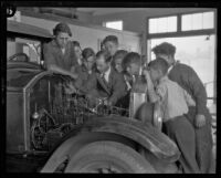 Students working on a car at the Jacob Riis High School, Los Angeles, 1930s