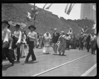 Consuela Castillo De Bonzo and mayor John Porter in a procession celebrating the opening of an extension of Spring street, Los Angeles, 1932