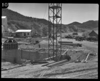 View of a generator and the reconstruction site of the Bureau of Power and Light's Power House #2, San Francisquito Canyon, 1928