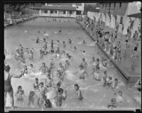 Crowds swimming in the reopened pool in Griffith Park, Los Angeles, 1934