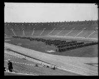 Panorama of police officers standing on the field at Los Angeles Memorial Coliseum during a police inspection, Los Angeles, 1927