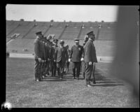 Commissioner Birnbaum and Chief Davis walk between rows of police officers during an inspection at Los Angeles Memorial Coliseum, Los Angeles, 1927