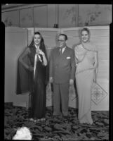 Grover Magnin and two models who are showing off the latest fashions from Paris, Los Angeles, 1935