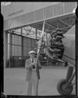 Aviator Paul Mantz poses next to plane, Los Angeles, ca. 1935