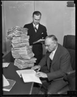Clifton H. Jack and Judge John J. Marquette with a gigantic stack of tax documents, Los Angeles, 1935