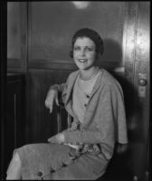 Madge Mitchell seated in a court house where she filed a lawsuit against William N. Fleischmann, Los Angeles, 1930