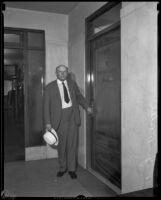 Wells J. Mosher, ex-confidential secretary to Mayor Porter, standing at the Grand Jury entrance door, Los Angeles, 1932