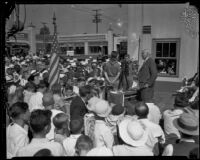 Governor Merriam, with two boy scouts, speaks to a gathering, Los Angeles County, 1935-1938