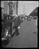 Governor Merriam beside his parked car, Los Angeles, 1934-1938