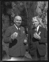 Lieutenant Governor Merriam and Robert Brennan pose with hamburgers at the annual Iowa picnic at Lincoln Park, Los Angeles, 1933