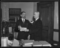 Judge Jeremiah Neterer in his office with U. S. Marshall Chilty (?), Los Angeles, 1935