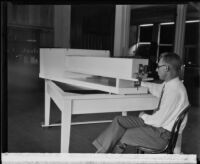 Dr. Seth B. Nicholson sits at his spectroscope, Pasadena vicinity, 1929