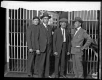 Jailer, Detective Paul Stevens, Cyrus G. Northcutt and Deputy Sheriff C. A. Quinn pose outside a jail cell, Riverside, 1928