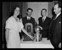 Pilot Gladys O'Donnell and three unidentified men with Aerol Trophy, [Los Angeles?], [1932?]